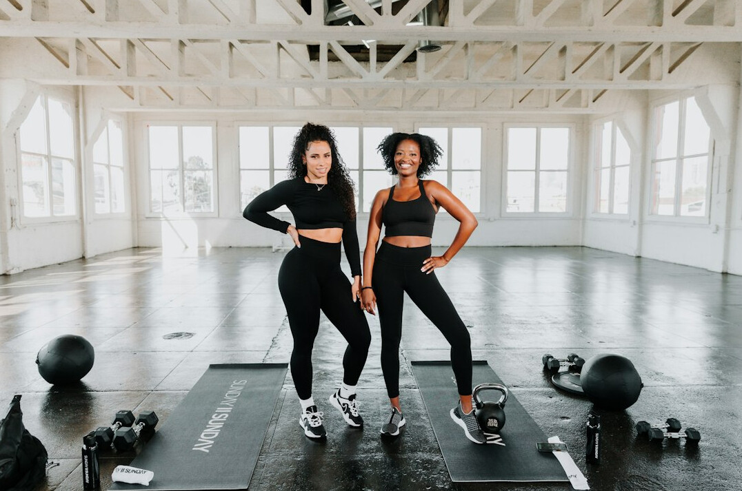 Group fitness class with women exercising together