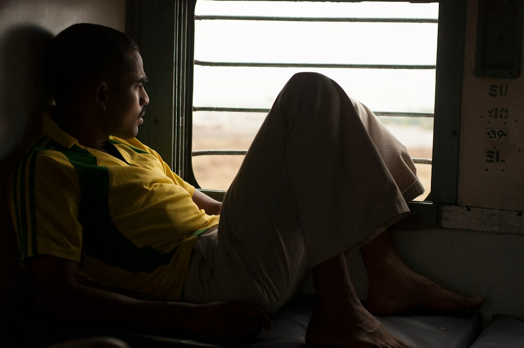 person meditating in quiet office corner