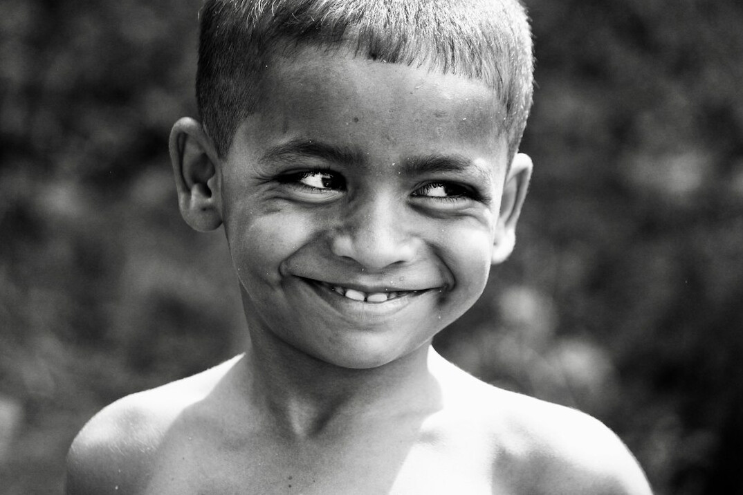 Portrait of a man with short hair smiling